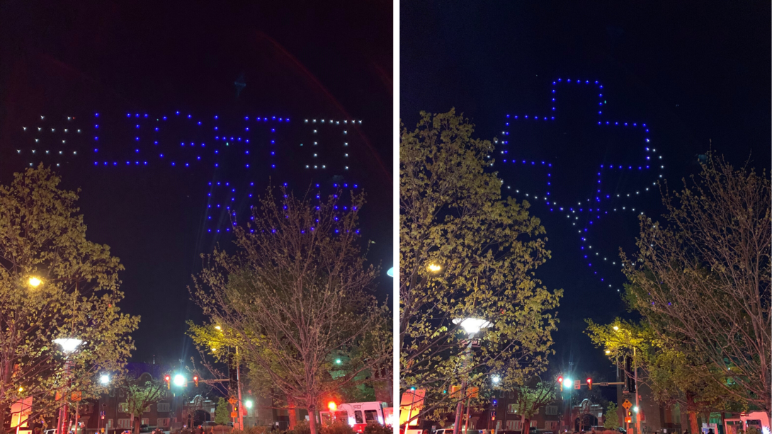 "light it blue" written in the sky with drones through the trees